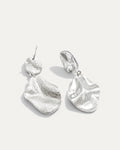 Silver dangle earrings with abstract sculptural design and fluid shape