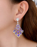 Amethyst cascade gold drop earrings on ear with purple zirconia elegant women