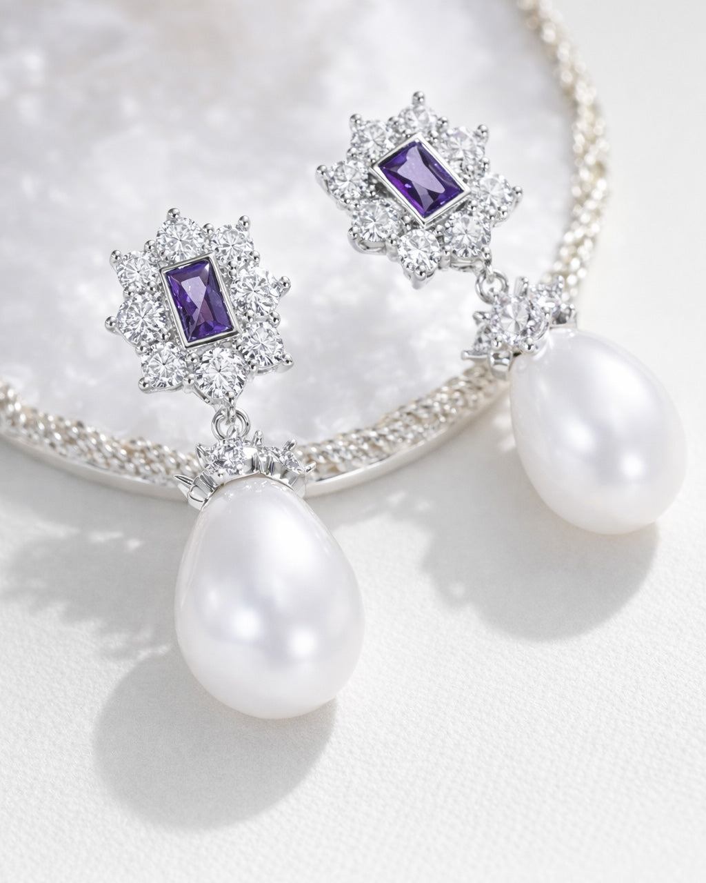 Amethyst pearl drop earrings with cubic zirconia halo silver plated flat lay
