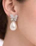 Butterfly pearl drop earrings silver plated cubic zirconia on-ear close up view