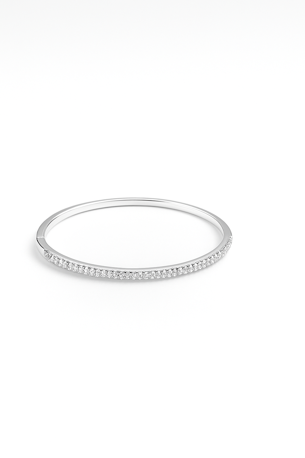 Silver bangle with small stones on a white background