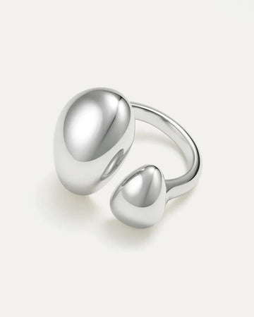 Silver ring with two rounded elements on a light gray background