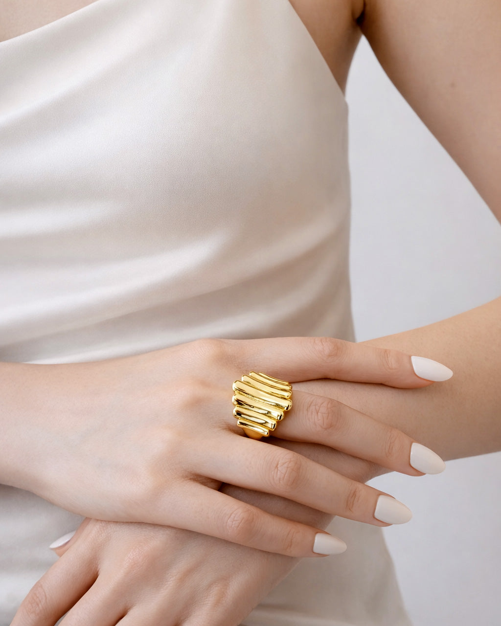 18K gold-plated bold cascade ring on model hand, modern minimalist jewelry style