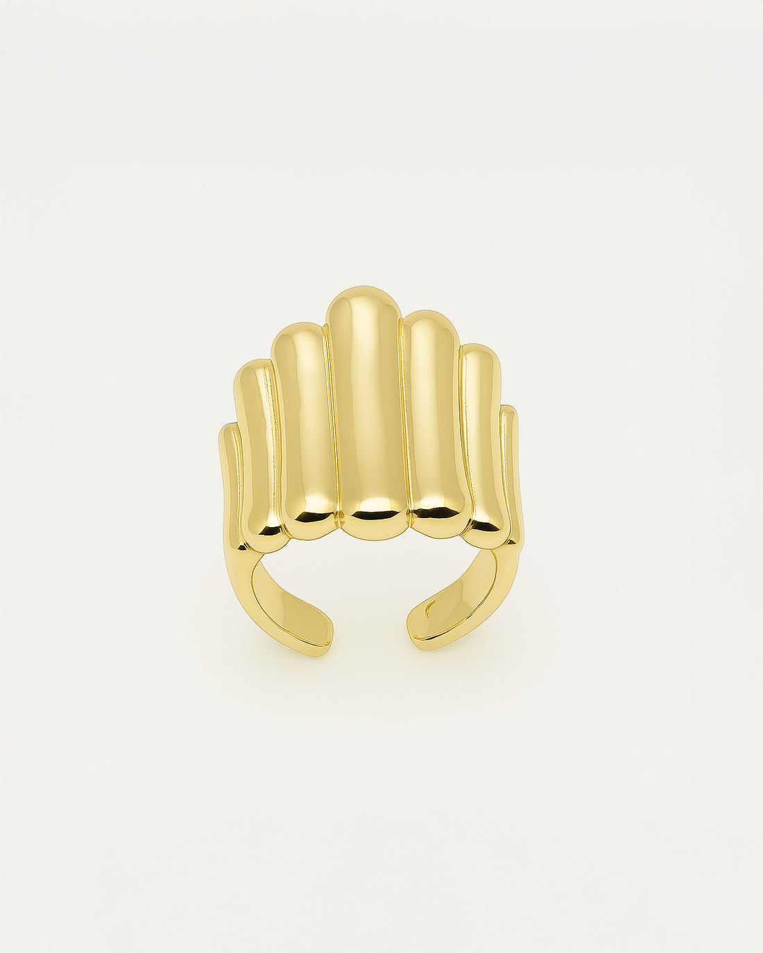 Gold statement ring with bold vertical ridges in a cascading sculptural design