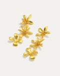 Gold-plated cascading flower drop earrings featuring three dimensional daisy designs stacked vertically, measuring 79mm in length with delicate petal details