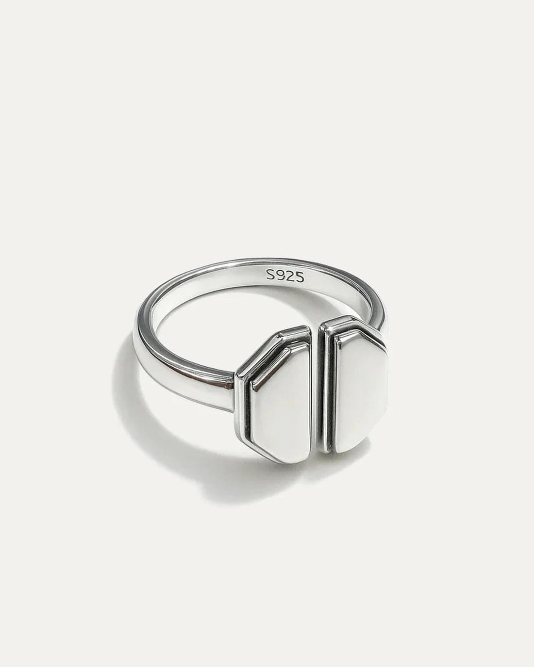 Silver ring with geometric design on a white background