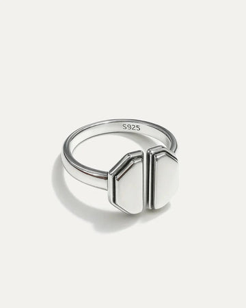 Silver ring with geometric design on a white background