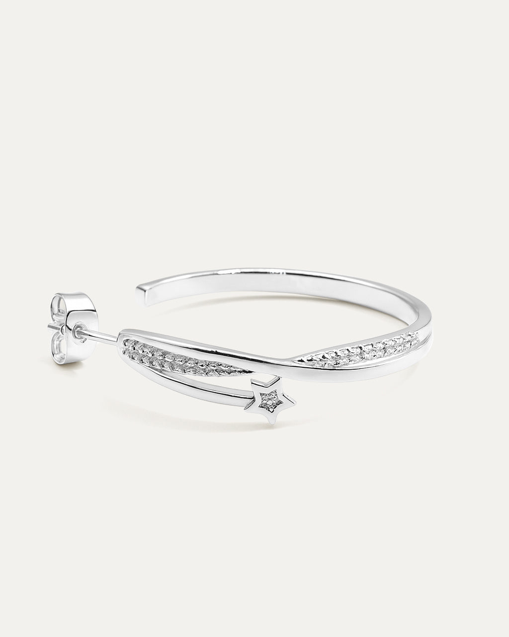 Silver bangle with star design on a white background