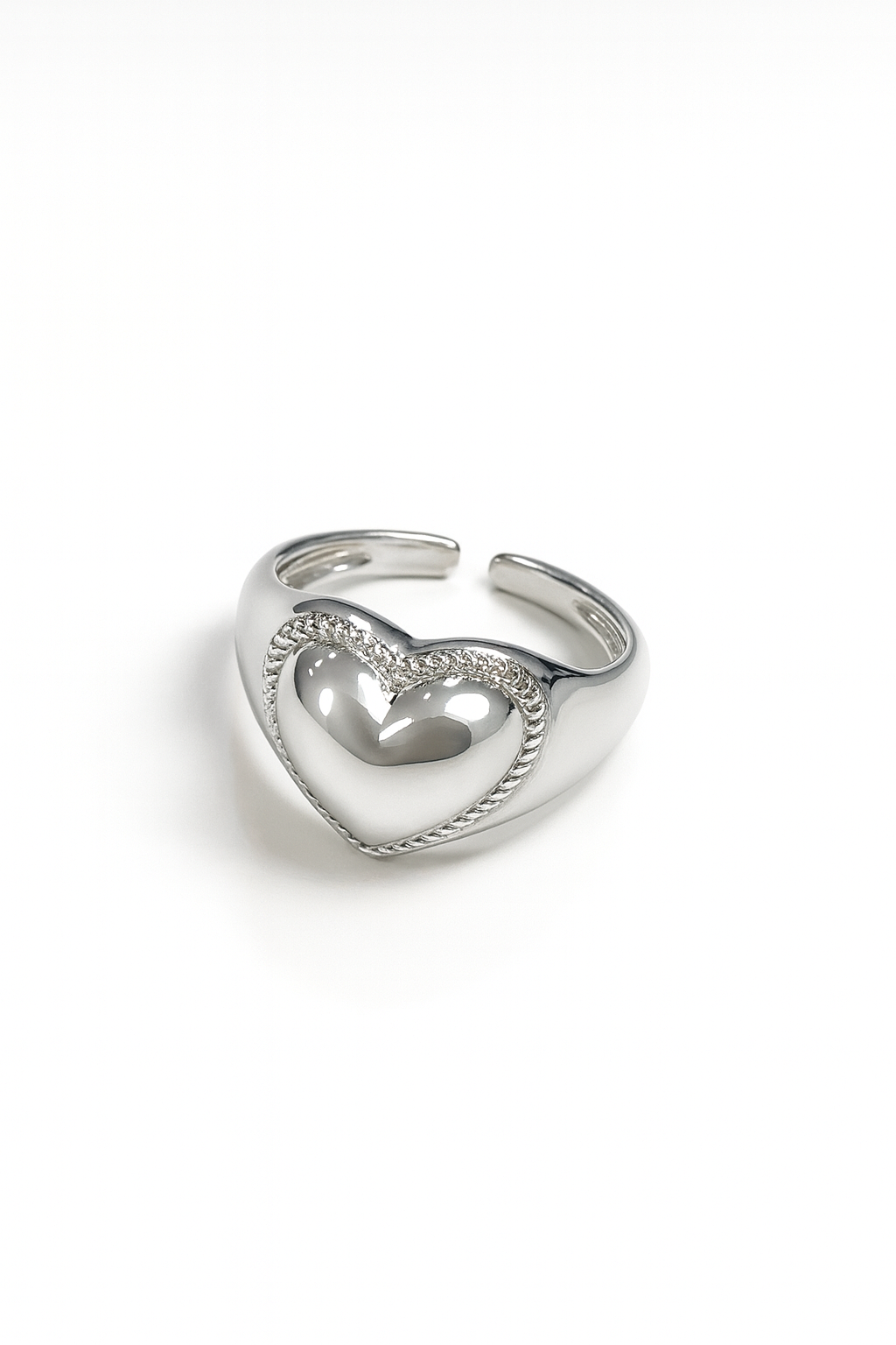 Silver heart-shaped ring on a white background
