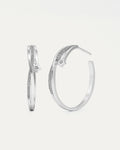 Pair of silver hoop earrings with small diamonds on a light gray background