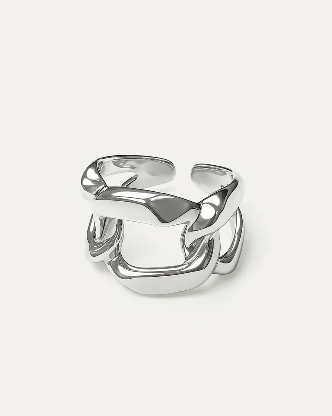A close-up studio shot of a chunky, adjustable silver-tone ring on a plain white or light beige background.  