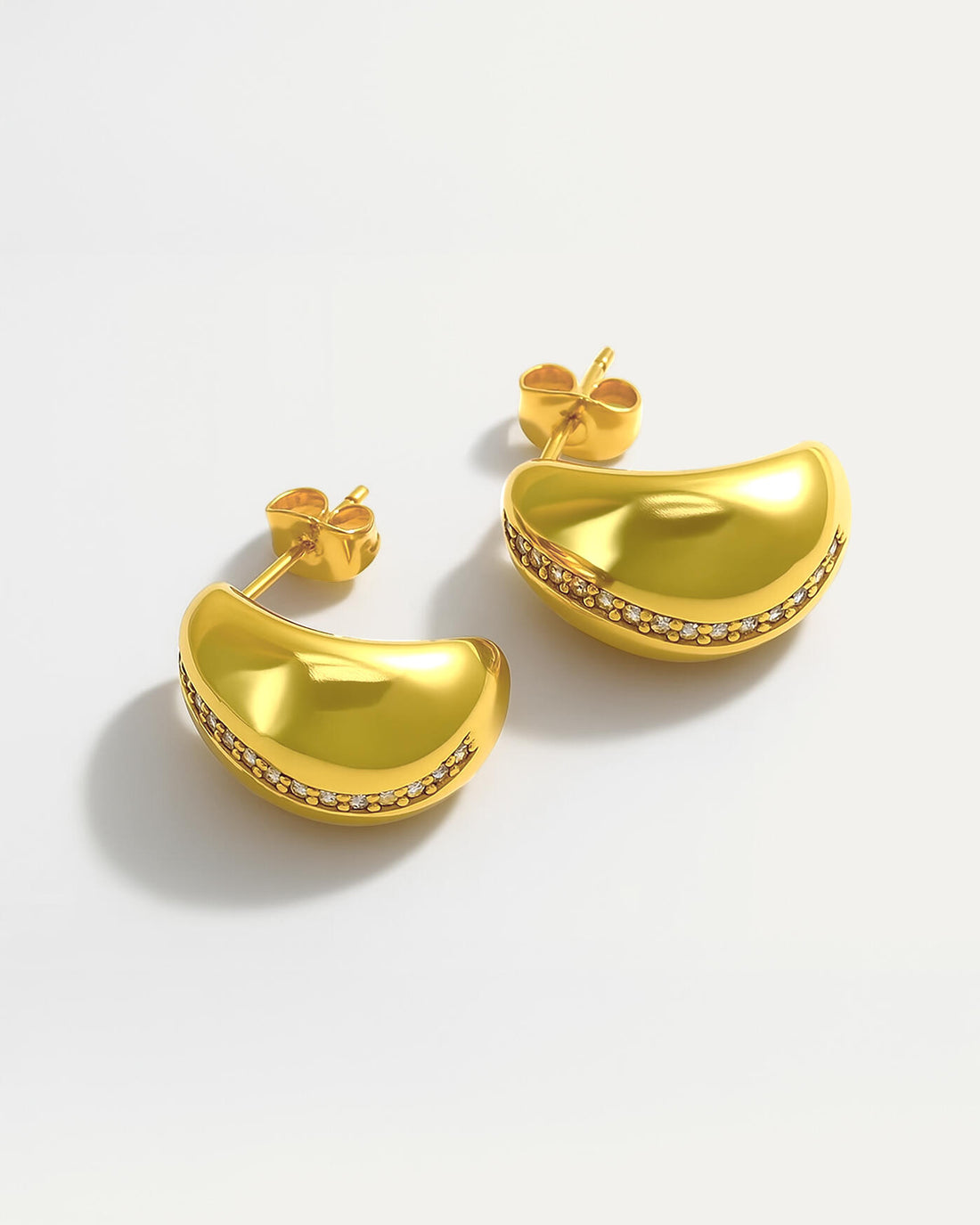 18k gold plated curved stud earrings with a diagonal line of crystals across smooth polished surface