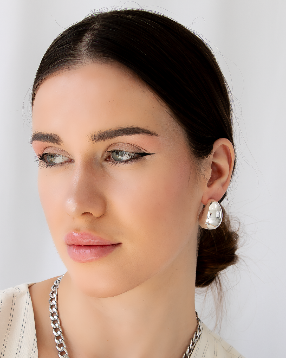 Pair of silver hoop earrings on a white background