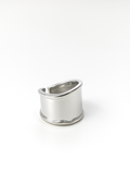 silver-plated wide band statement ring with curved top and open back design on white background