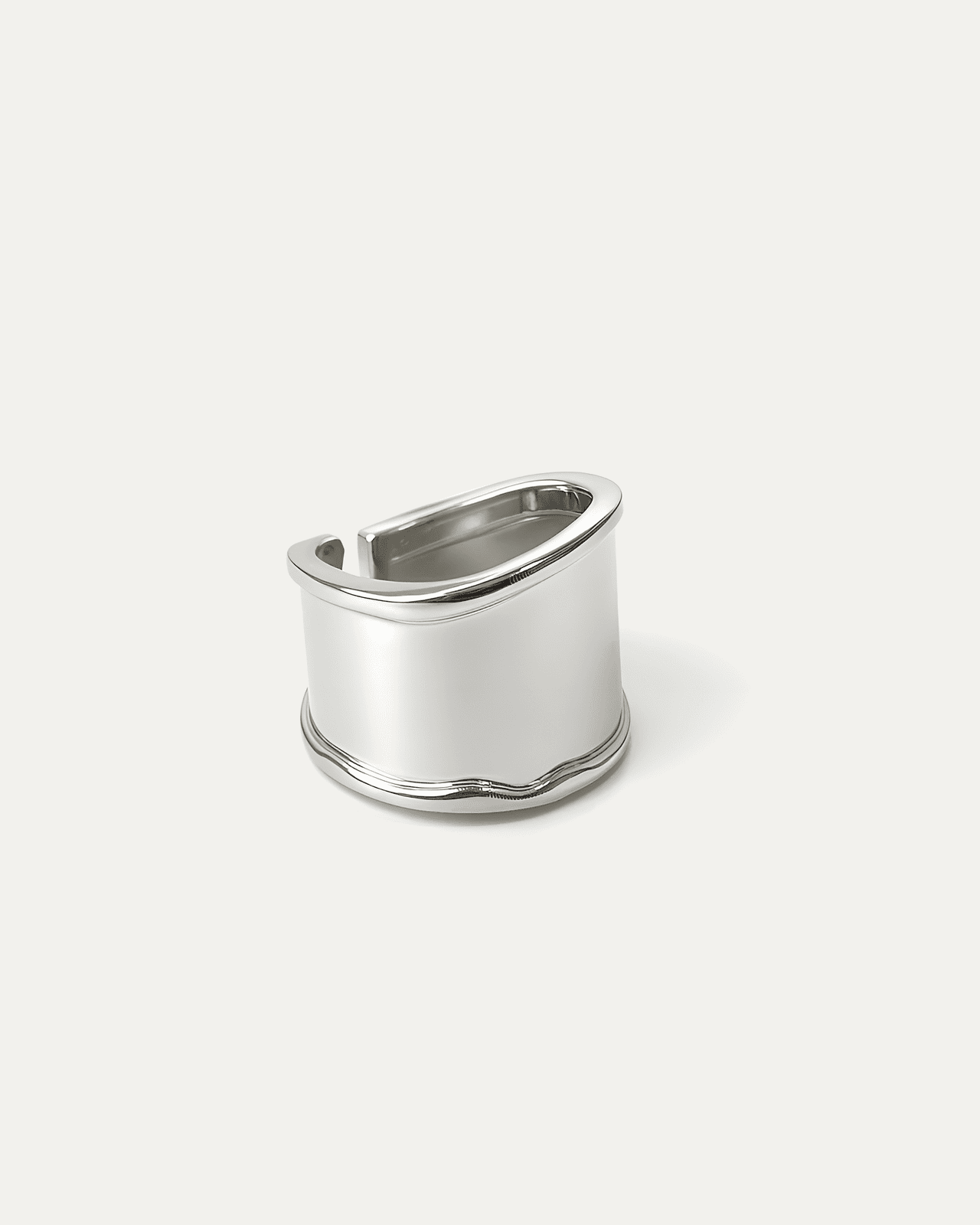 silver-plated wide band statement ring with curved top and open back design on white background