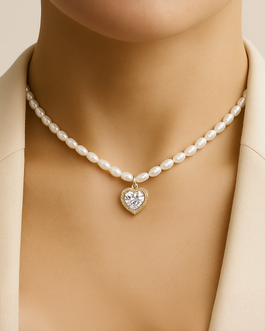 Pearl necklace with a heart-shaped diamond pendant on a neutral background
