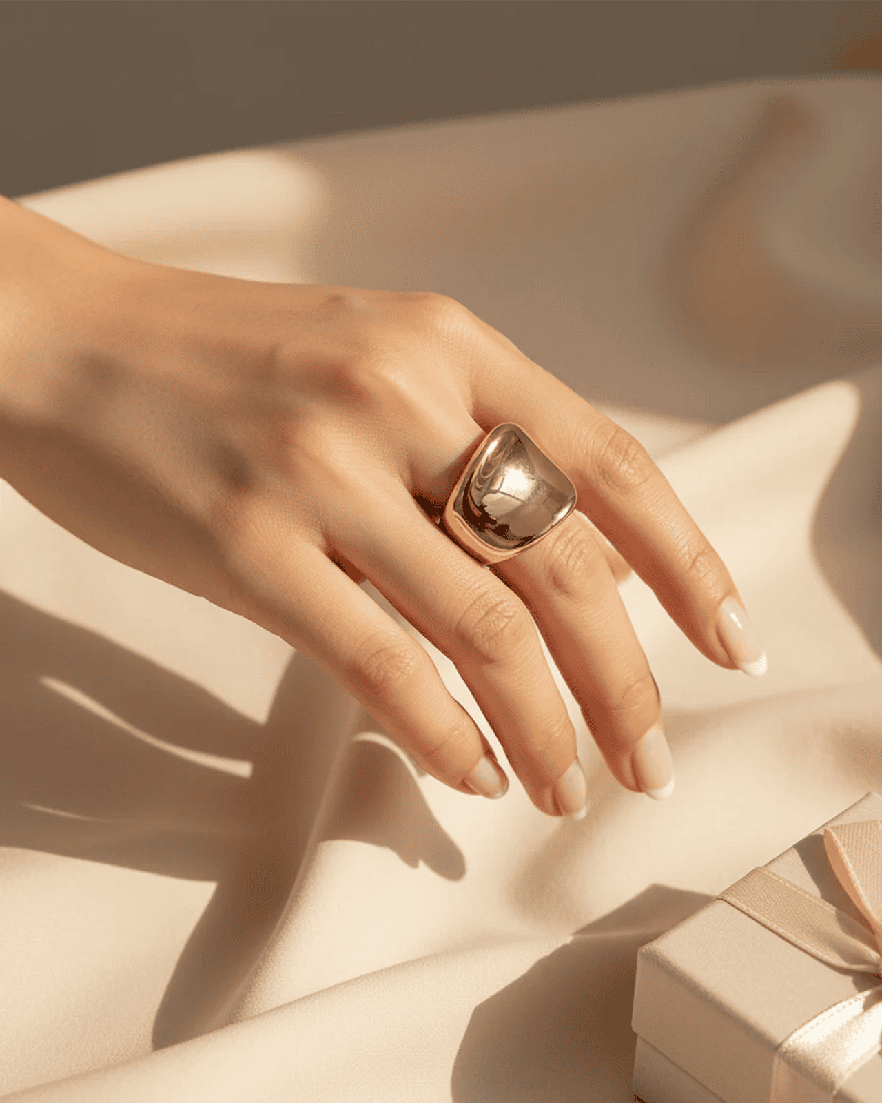 Gold open statement ring with a smooth domed curve and minimal design