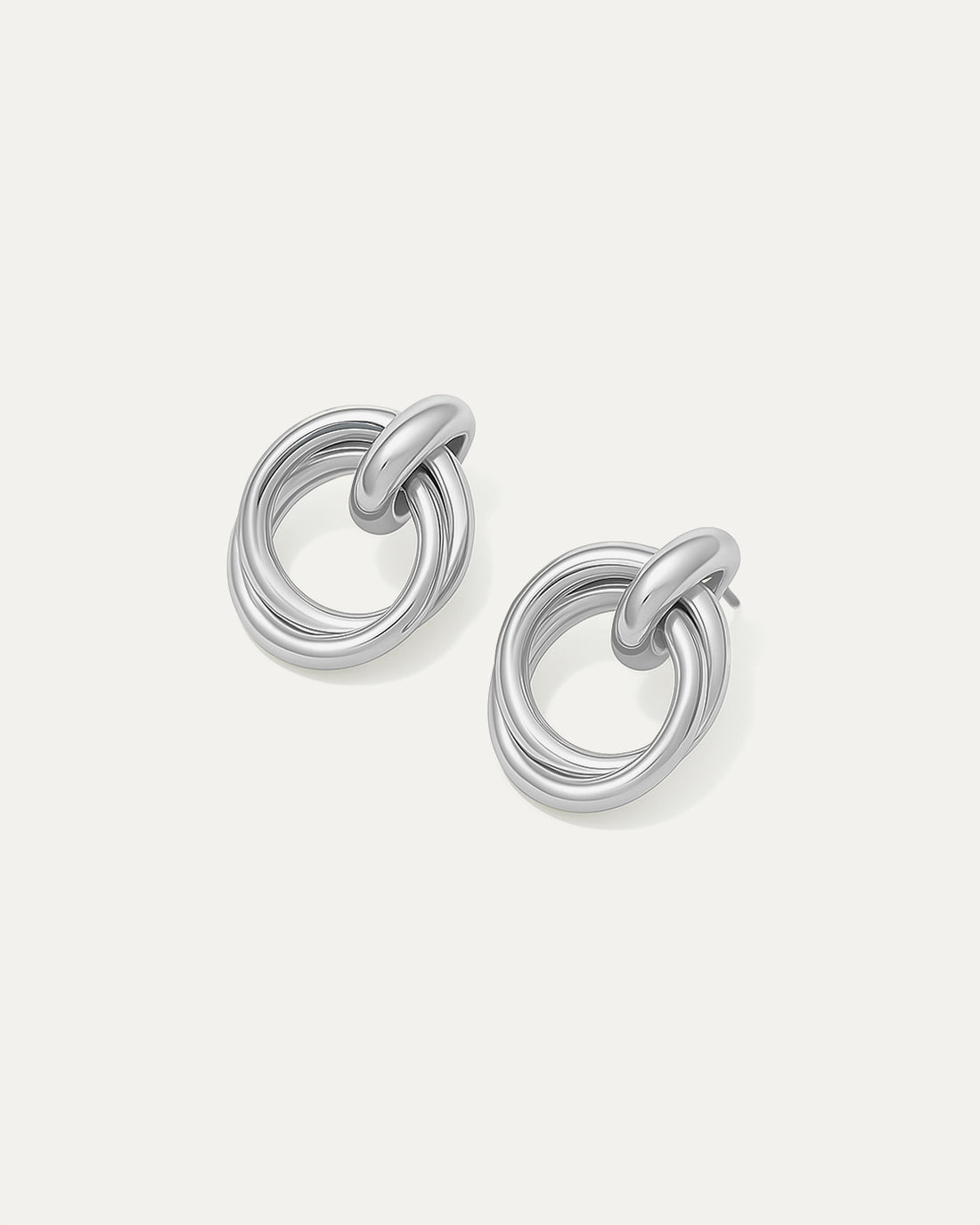 Shop Double Round Studs – interlocked silver-plated earrings with a minimalist sculptural look. Lightweight and versatile for everyday wear.