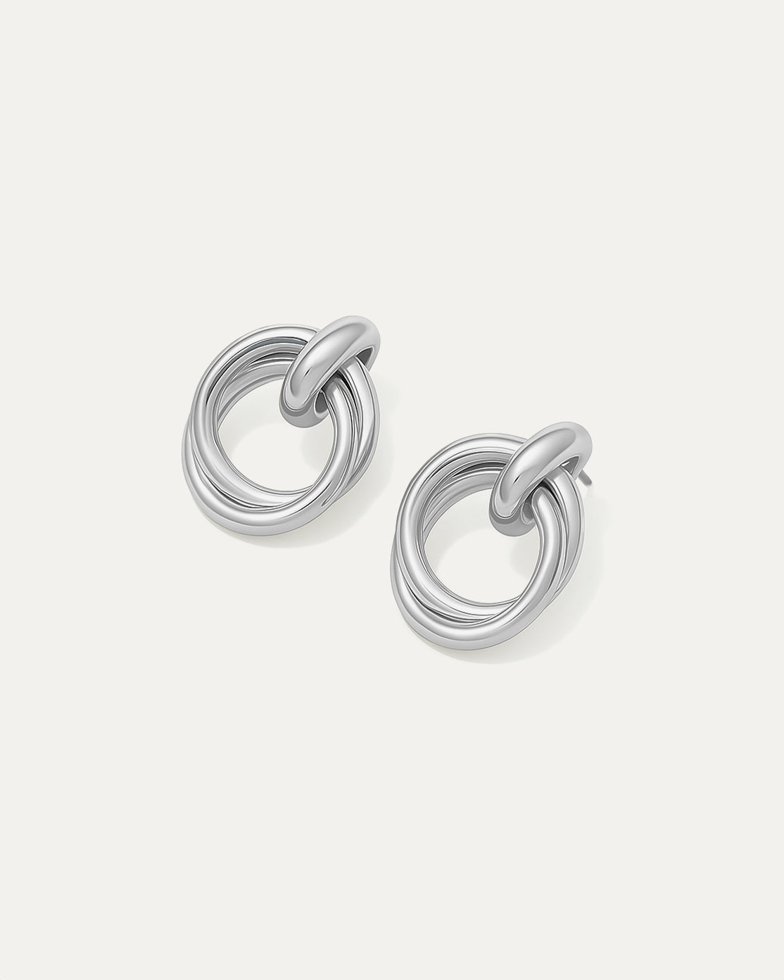 Shop Double Round Studs – interlocked silver-plated earrings with a minimalist sculptural look. Lightweight and versatile for everyday wear.