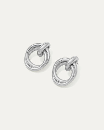 Shop Double Round Studs – interlocked silver-plated earrings with a minimalist sculptural look. Lightweight and versatile for everyday wear.