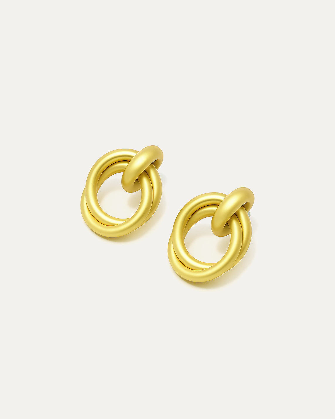 Pair of gold knot earrings on a white background