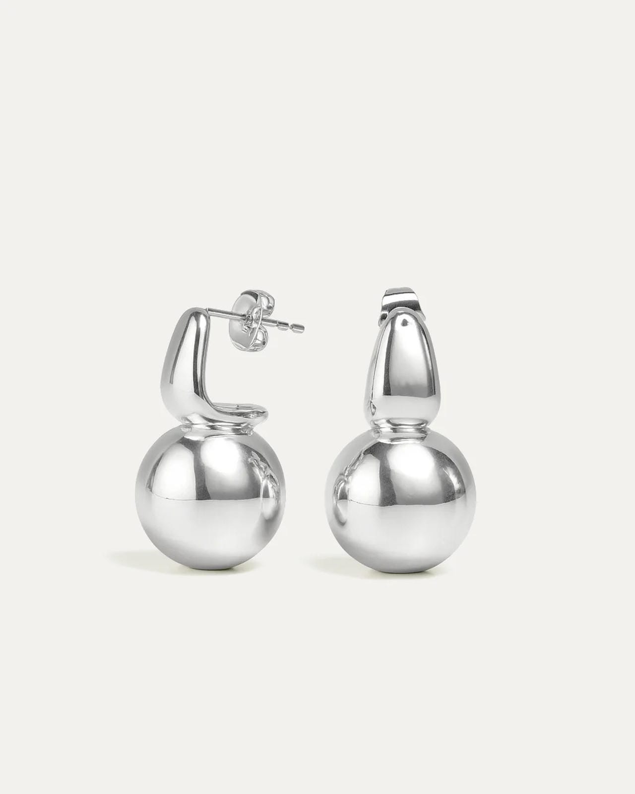 Pair of duo orbit silver hoop earrings on a light gray background