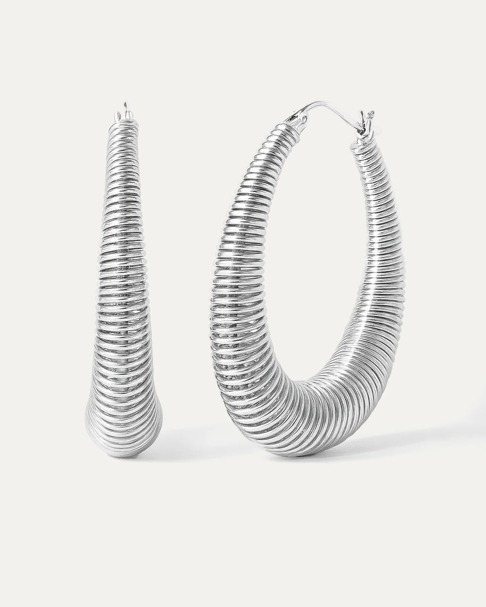 Pair of silver hoop earrings on a white background