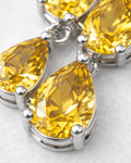 Yellow pear-cut zirconia stones in rhodium-plated brass setting