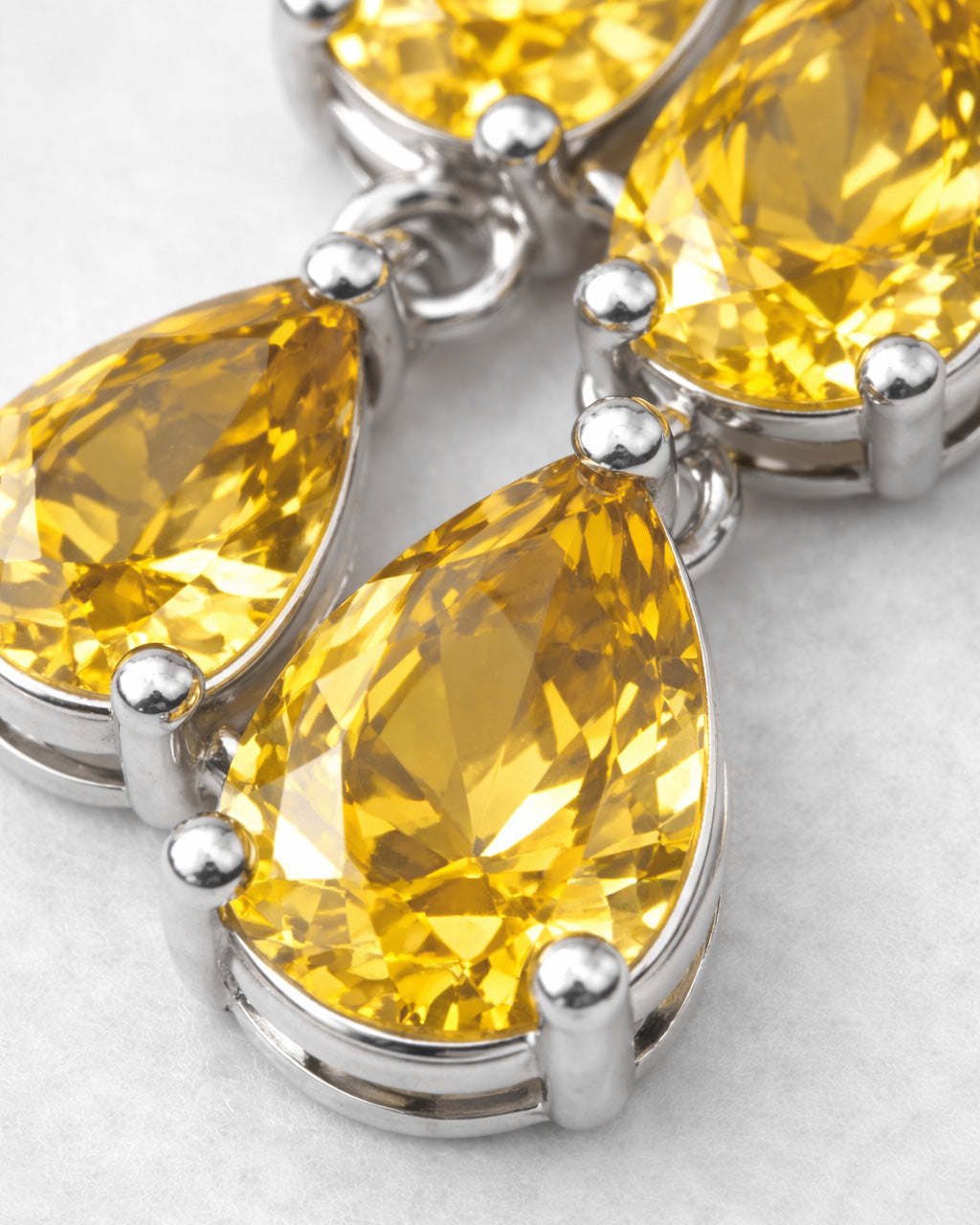 Yellow pear-cut zirconia stones in rhodium-plated brass setting