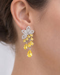 Floral cubic zirconia drop earrings with yellow stones worn on model, elegant look