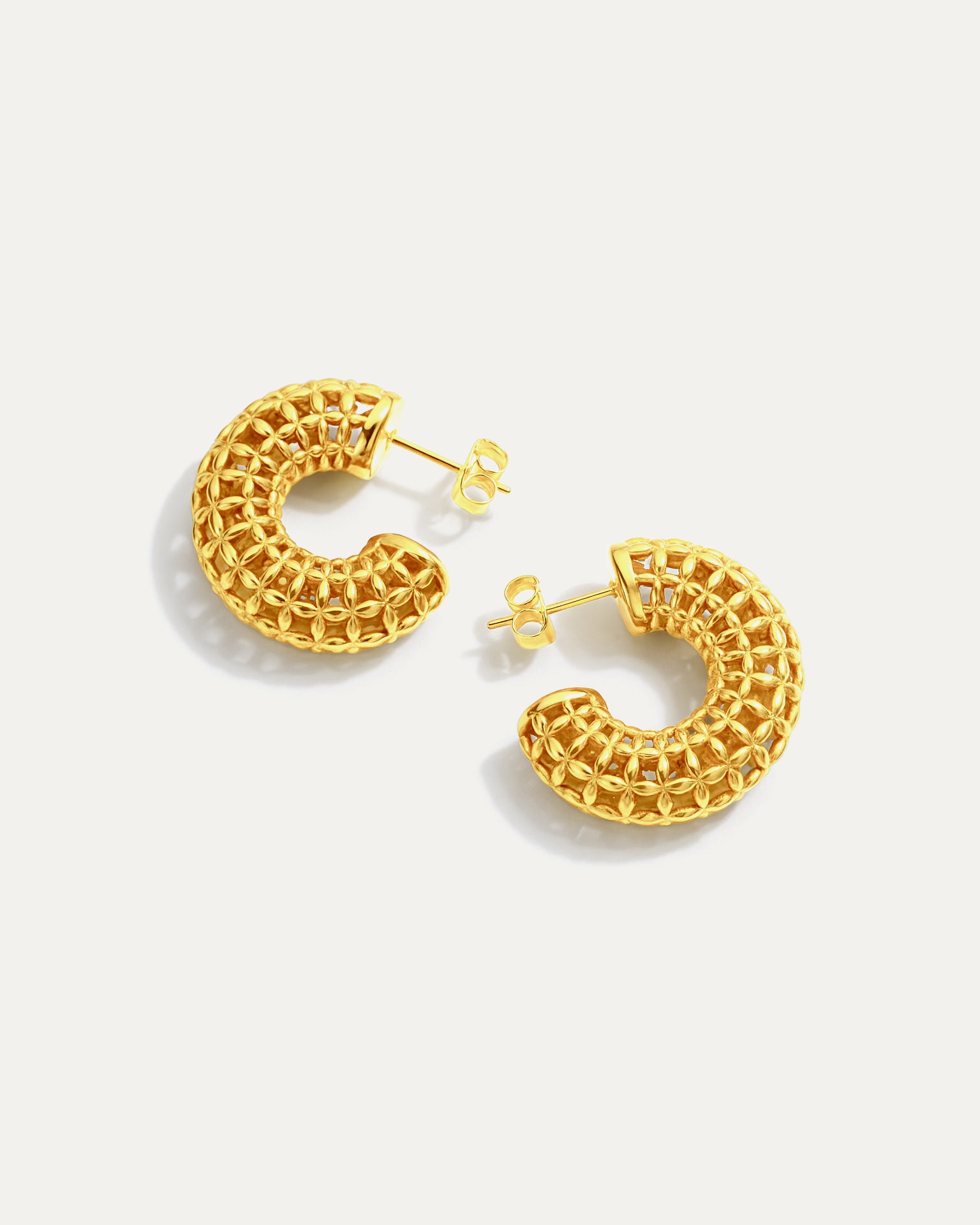 Gold hoop earrings on a white background