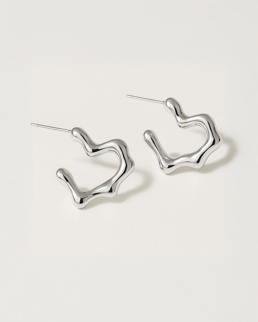 Silver hoop earrings on a light gray background