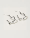Silver hoop earrings on a light gray background