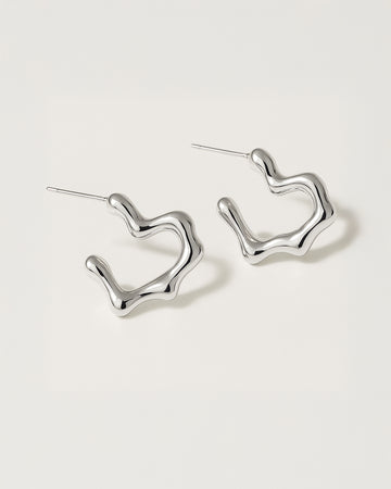 Silver hoop earrings on a light gray background