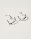 Silver hoop earrings on a light gray background