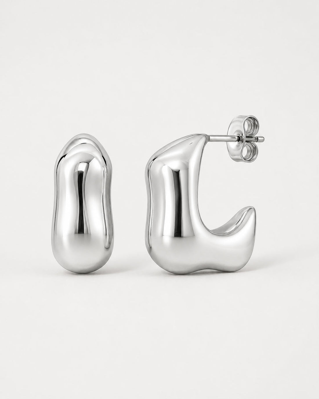 Silver hoop earrings on a light gray background