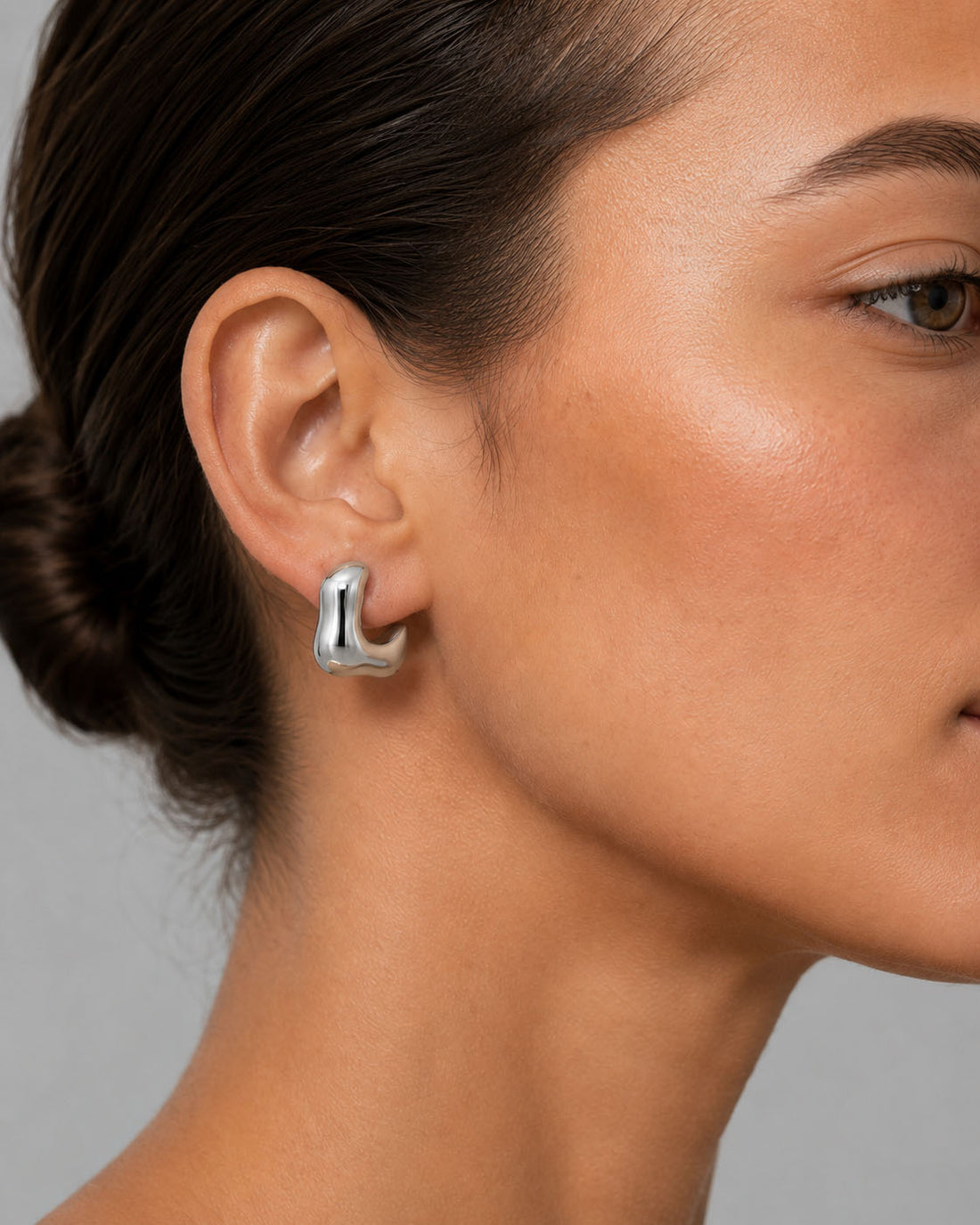 Silver hoop earrings on a light gray background