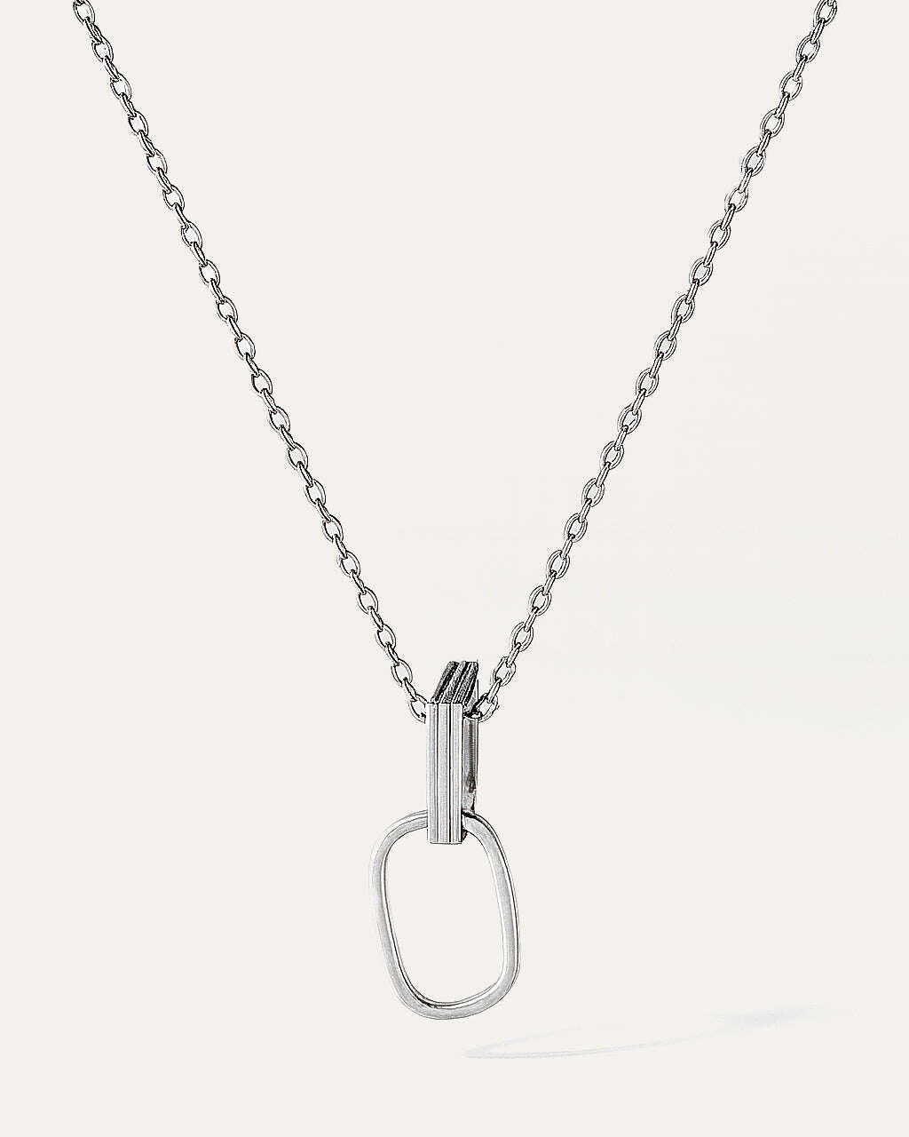 Silver necklace with a unique pendant on a white background