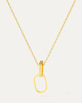 Gold necklace with a unique pendant on a light gray background