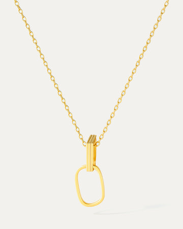 Gold necklace with a unique pendant on a light gray background