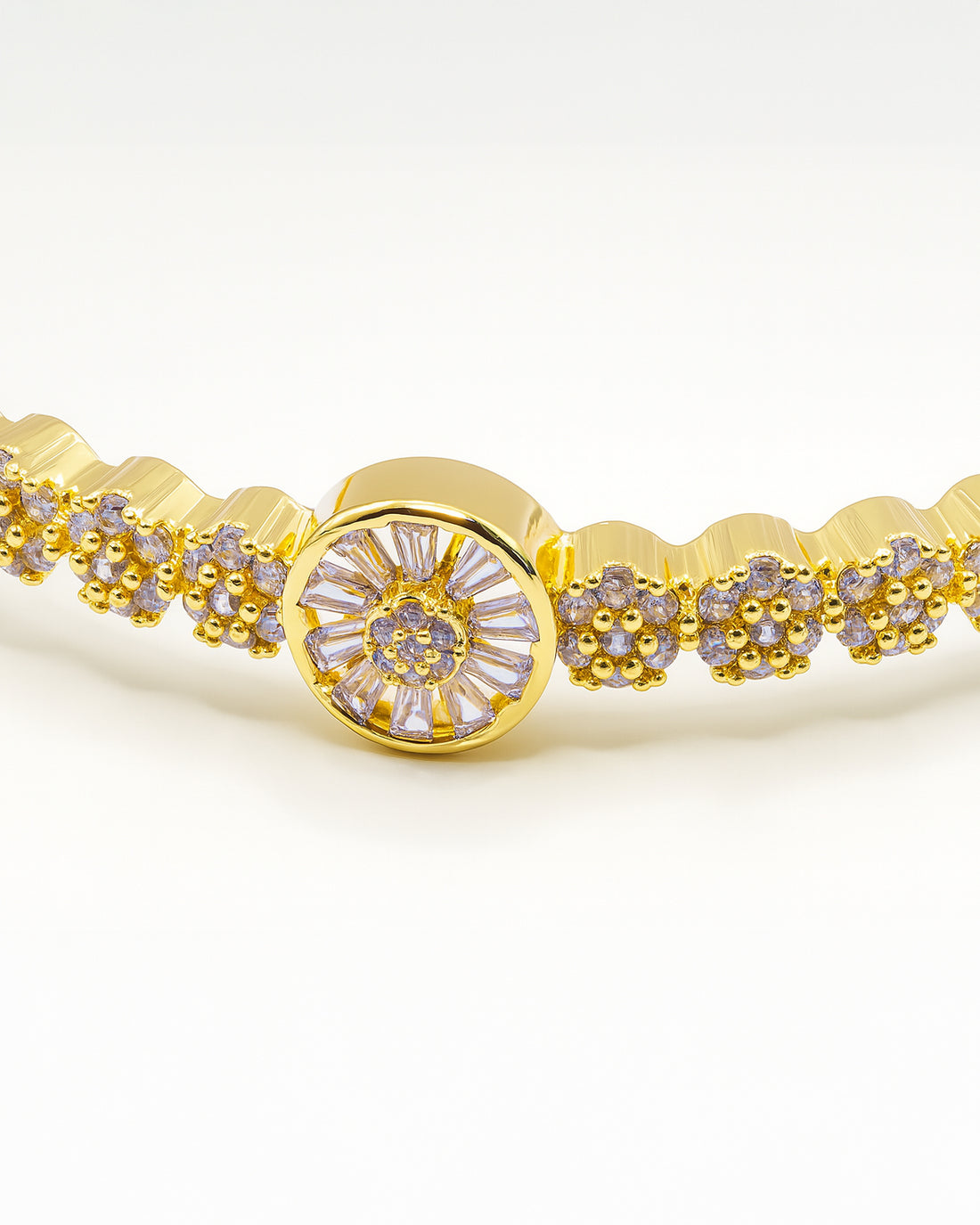 Gold bangle bracelet with floral centerpiece and sparkling crystals – Golden Bloom Radiance Bangle.