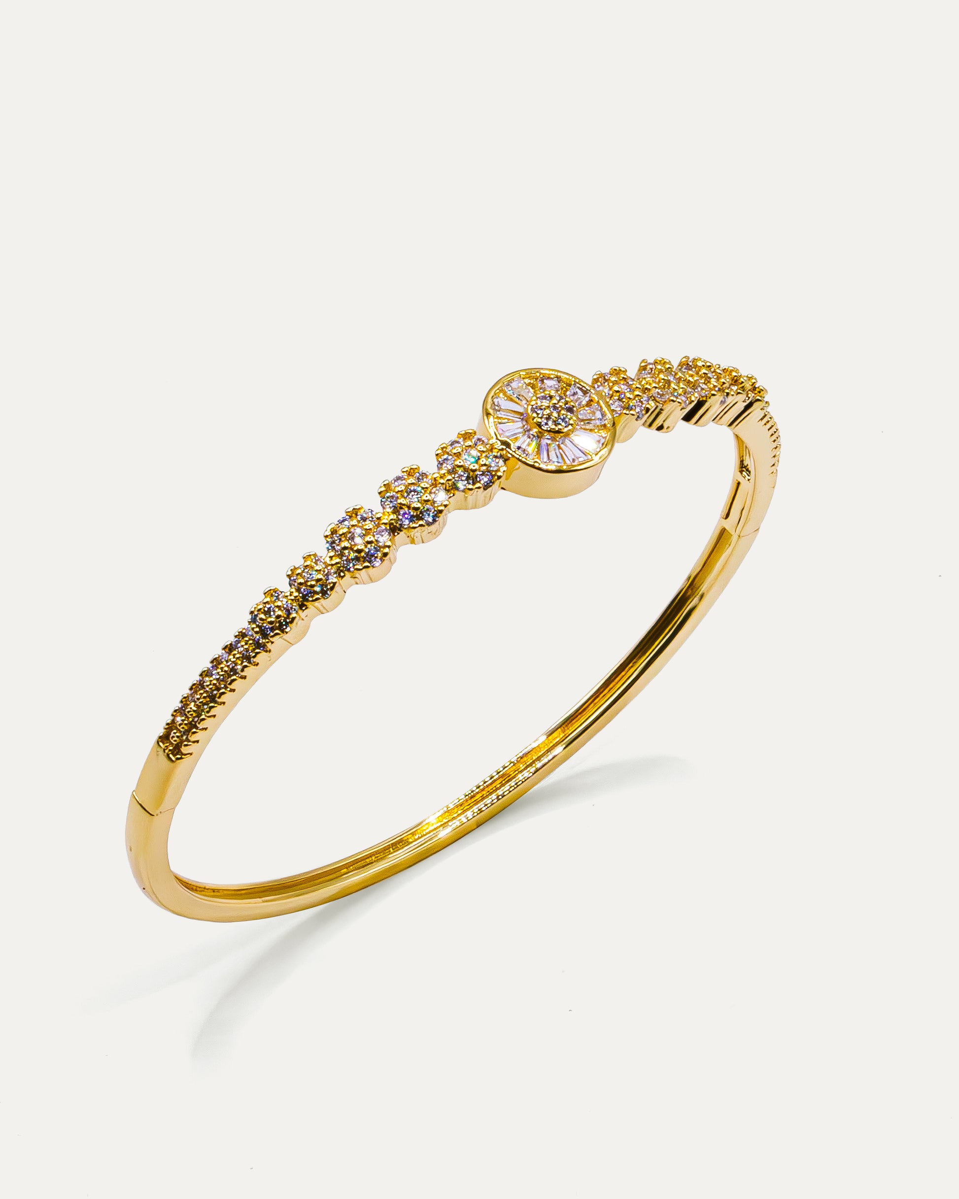 Gold bangle bracelet with floral centerpiece and sparkling crystals – Golden Bloom Radiance Bangle.