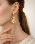 18K gold-plated floral drop earrings with pearl, elegant side view on model