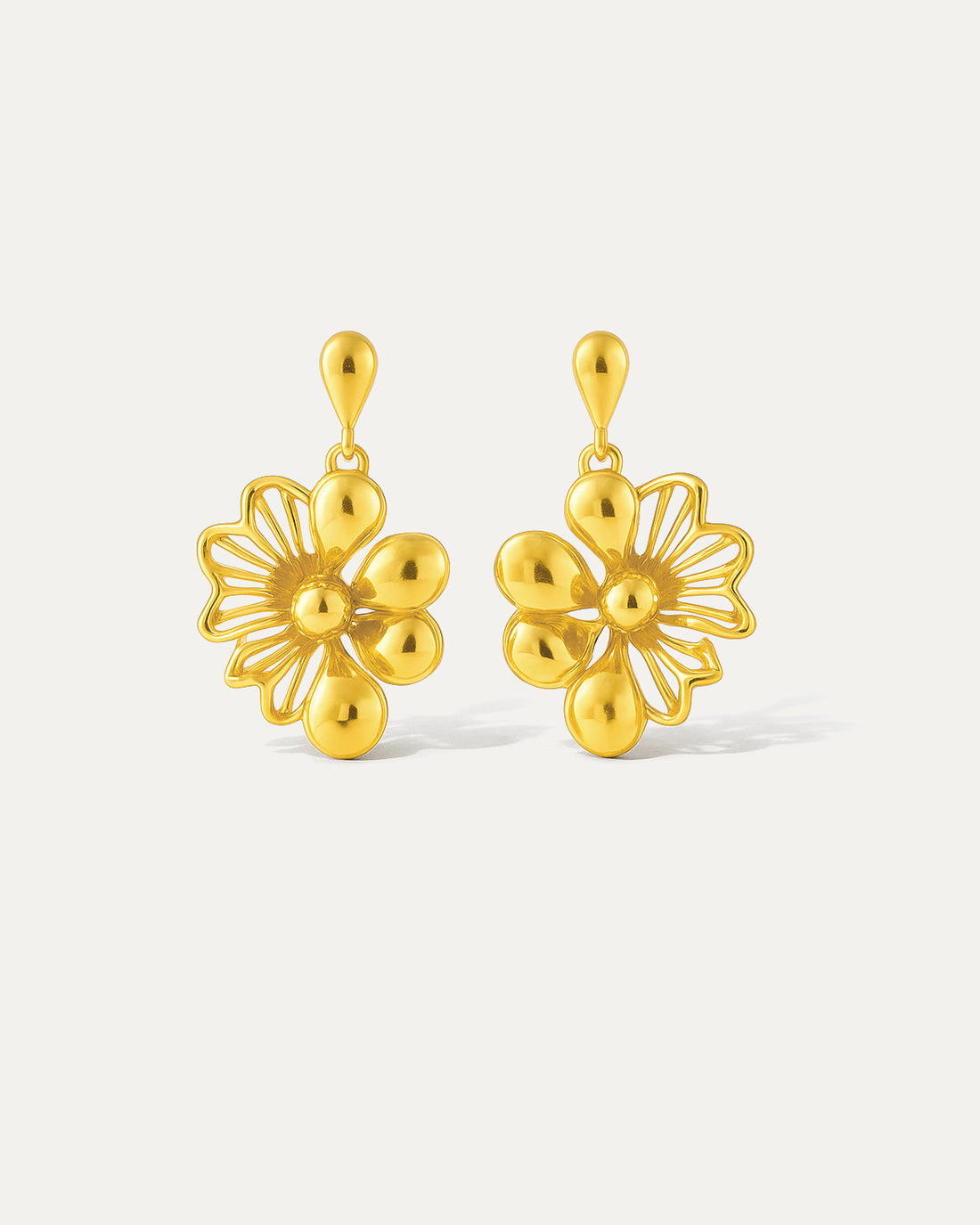 Intricate gold floral dangle earrings with a delicate chain. Perfect for adding a touch of elegance to any outfit.