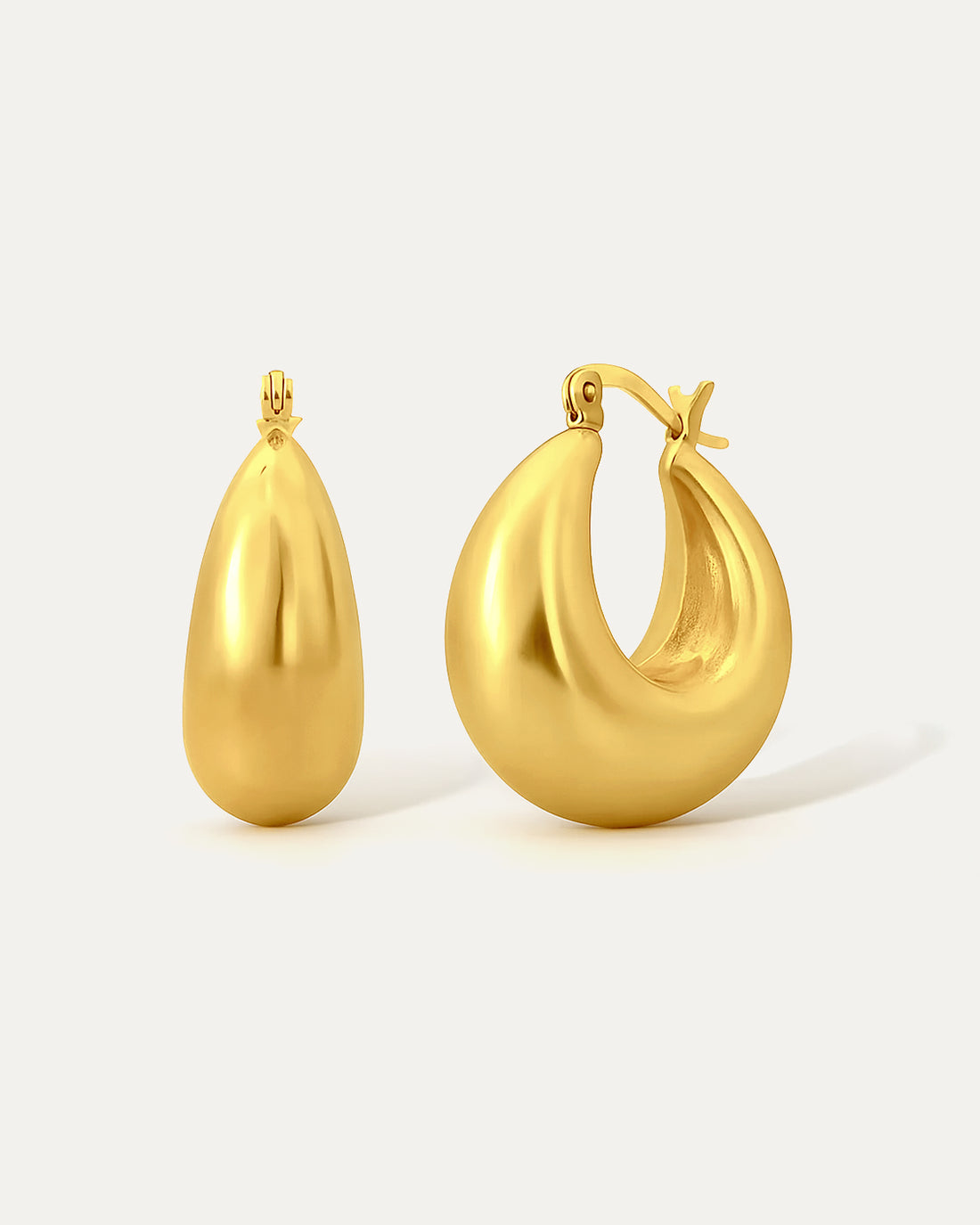 Gold hoop earrings on a light gray background