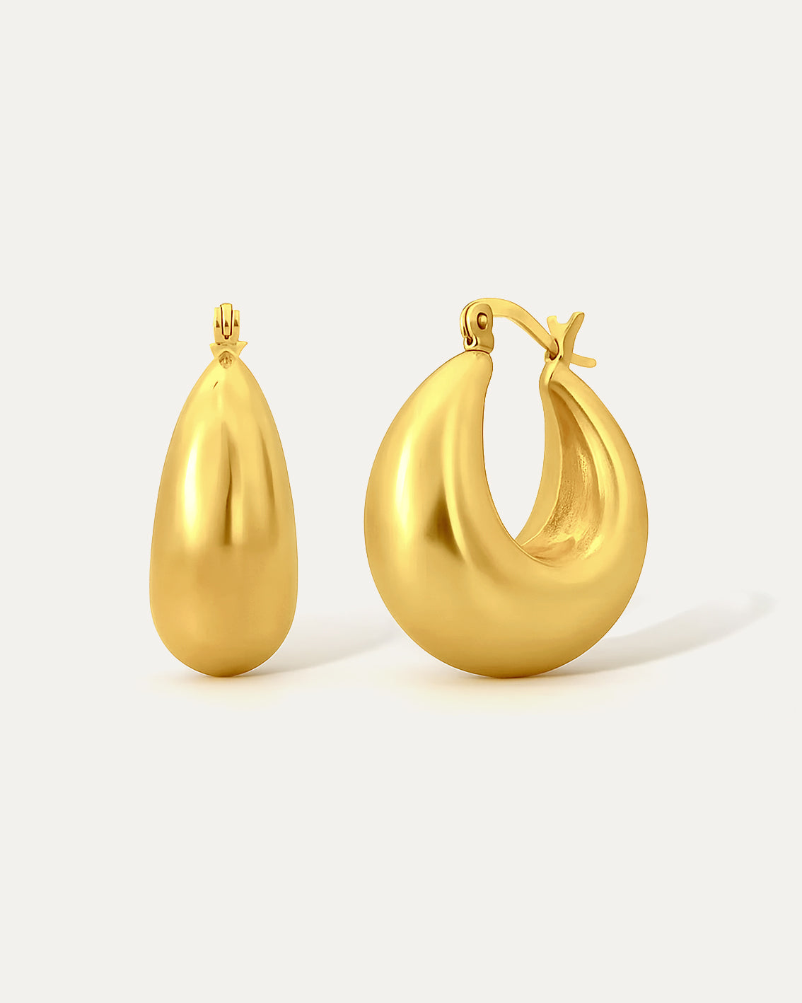 Gold hoop earrings on a light gray background