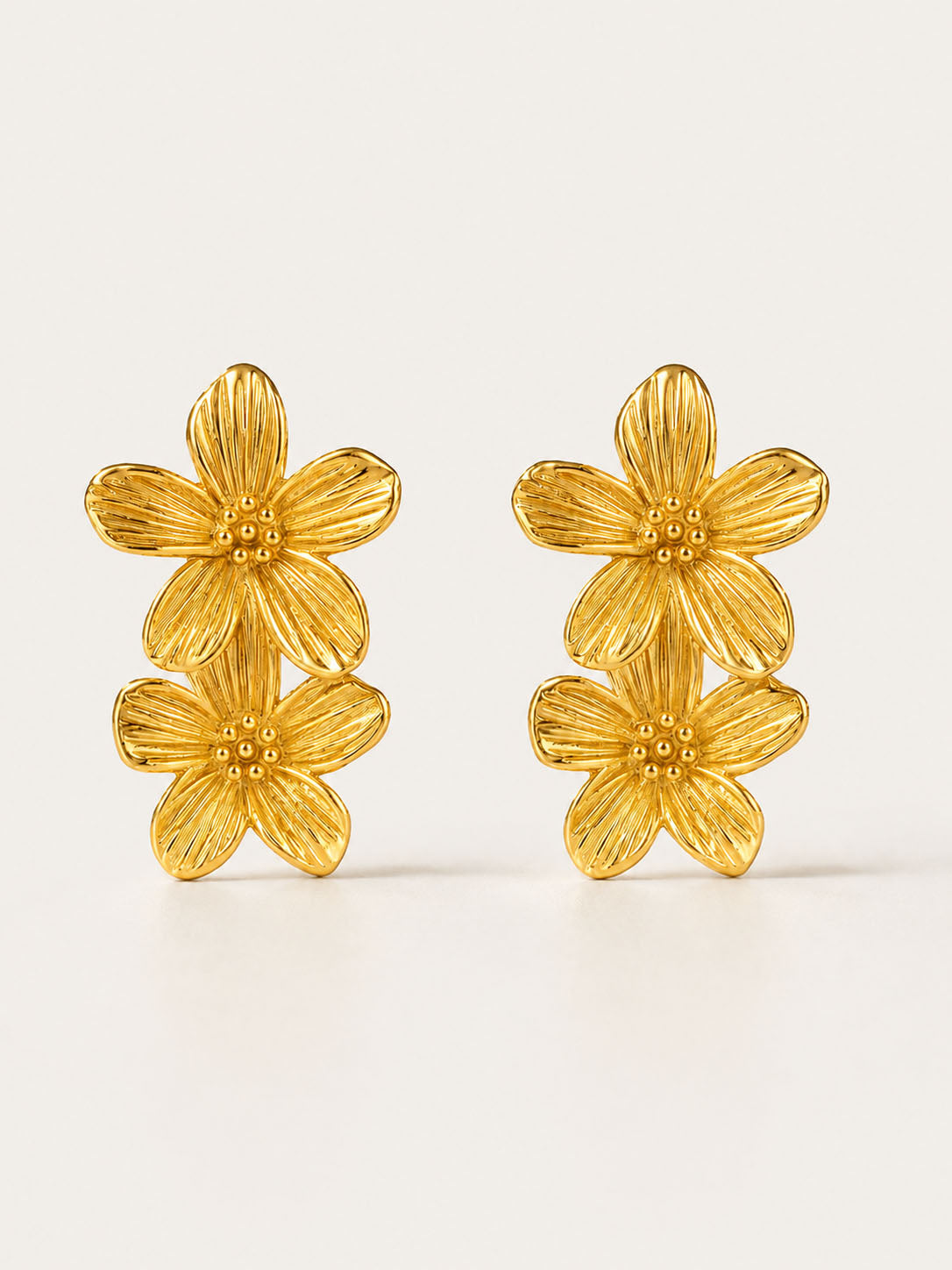 Gold floral stud earrings with double flower design and polished 18K gold-plated finish