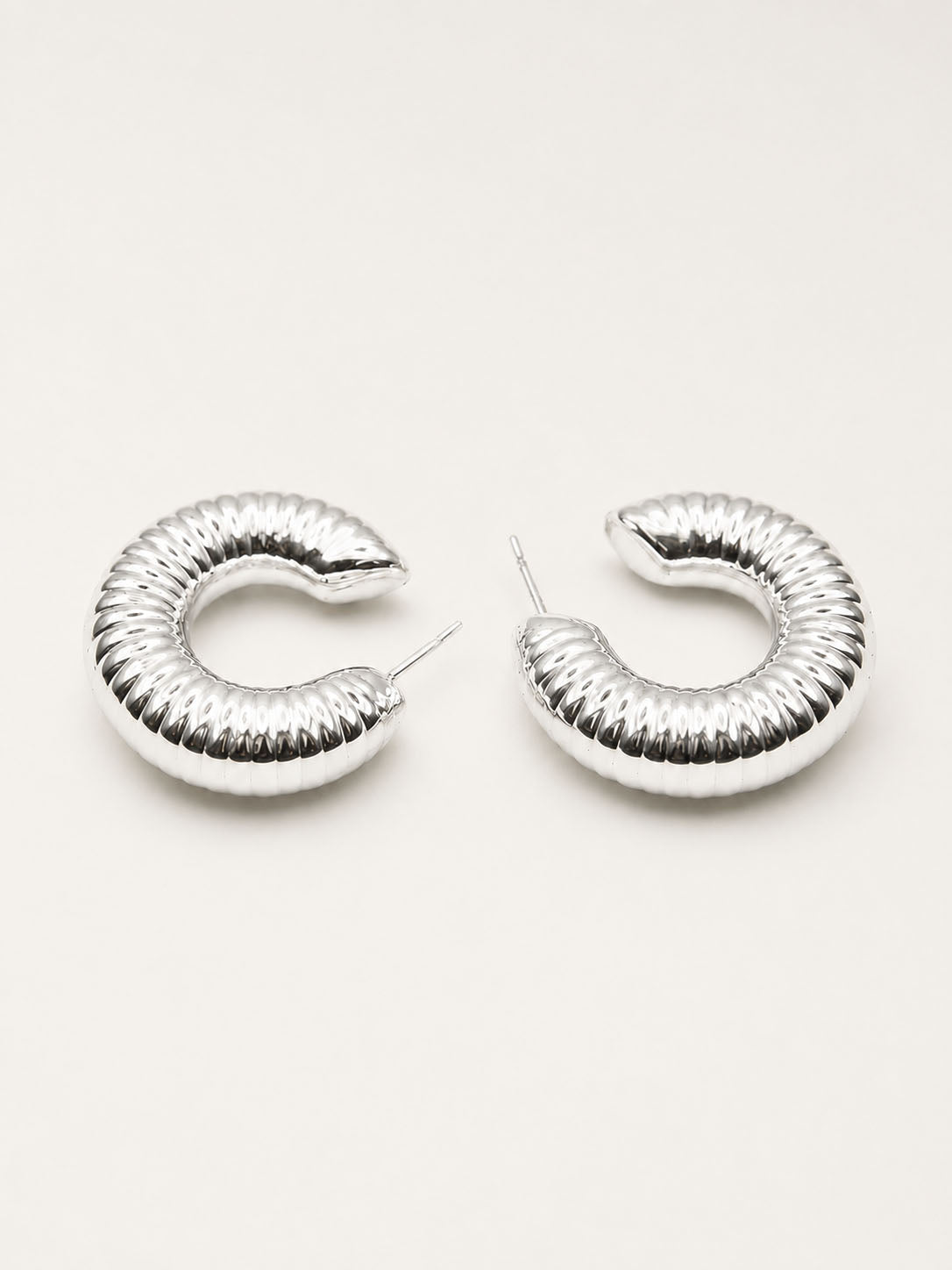 Silver grooved dome hoop earrings with ribbed curved design and polished silver-plated finish