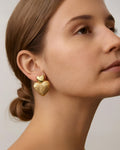 18K gold-plated hammered heart drop earrings on model, elegant statement jewelry