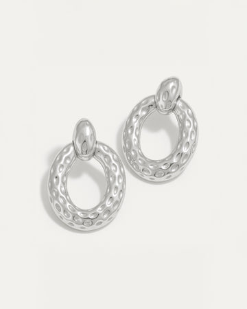 Silver hammered oval stud earrings with textured surface and high-polish finish – lightweight and sculptural.
